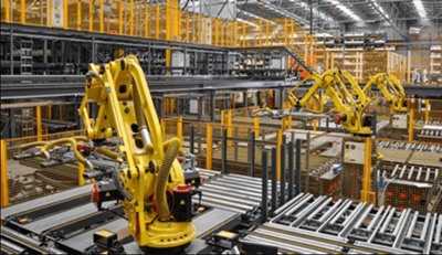 Modern warehouse with robotic arms and conveyor belts operating in an automated fulfillment environment.