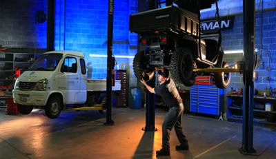 Werres technician working on a vehicle in a well-lit service garage with tools and equipment visible