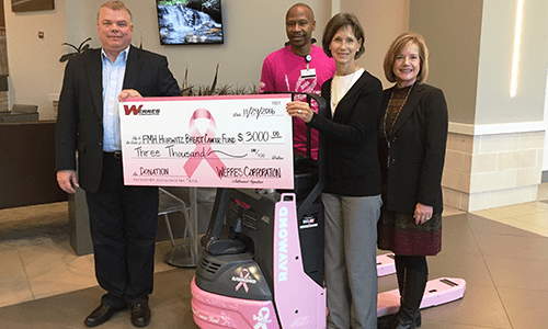 Werres Corporation President, Keith Burlingame, presenting 2016 fundraiser funds along with a customized Raymond 8210 to the Hurwitz Breast Cancer Fund