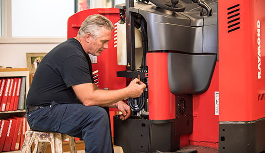 Werres technician conducting maintenance on a Raymond forklift as part of a government contract service